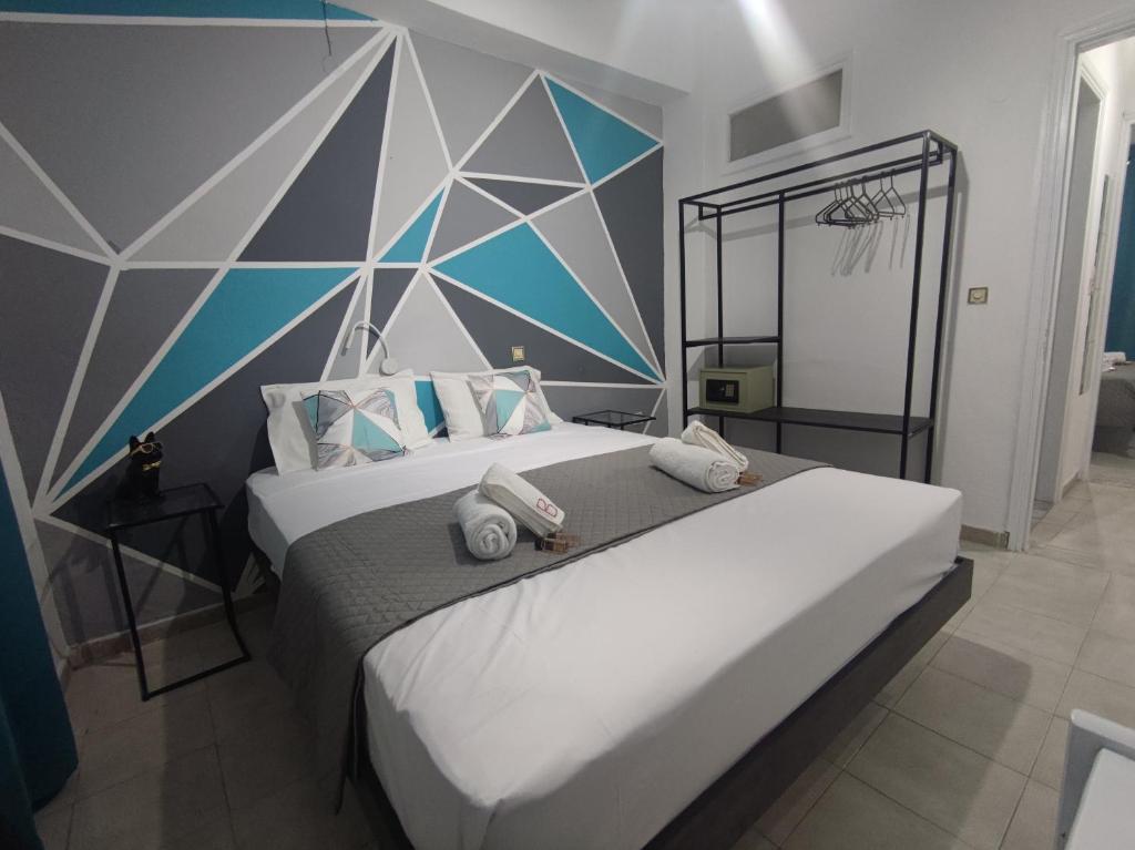 a bedroom with a large bed with towels on it at boulitos 2 in Kavos