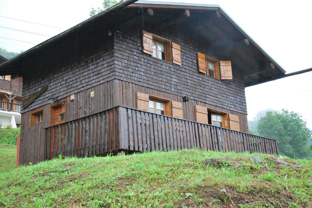 a building on top of a grassy hill at Chalet individuel tout équipé 2 Etoiles, 6 couchages in Le Grand-Bornand