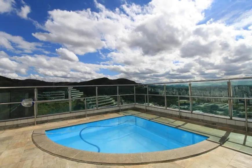 a swimming pool on the roof of a building at Flat completo em BH in Belo Horizonte