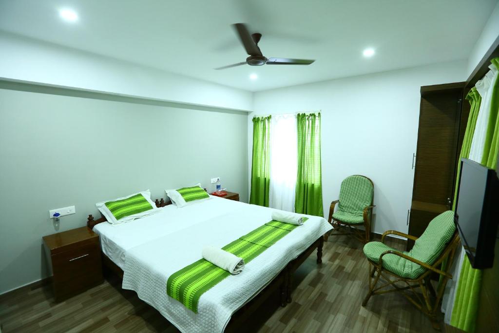 Ένα ή περισσότερα κρεβάτια σε δωμάτιο στο Mistygreen Homestay Thekkady
