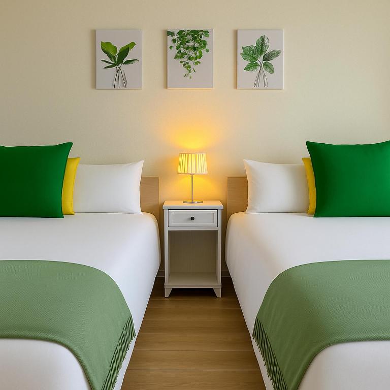 two beds sitting next to each other in a room at TOEI BUSSAN Building20 in Osaka