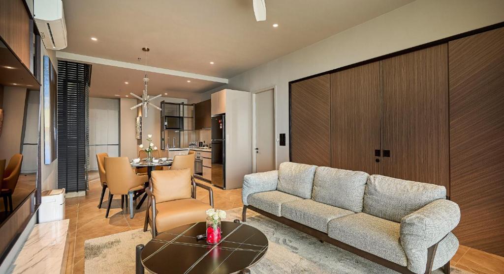 a living room with a couch and a table at Antara Genting Highlands by COBNB - near Link Bridge in Genting Highlands