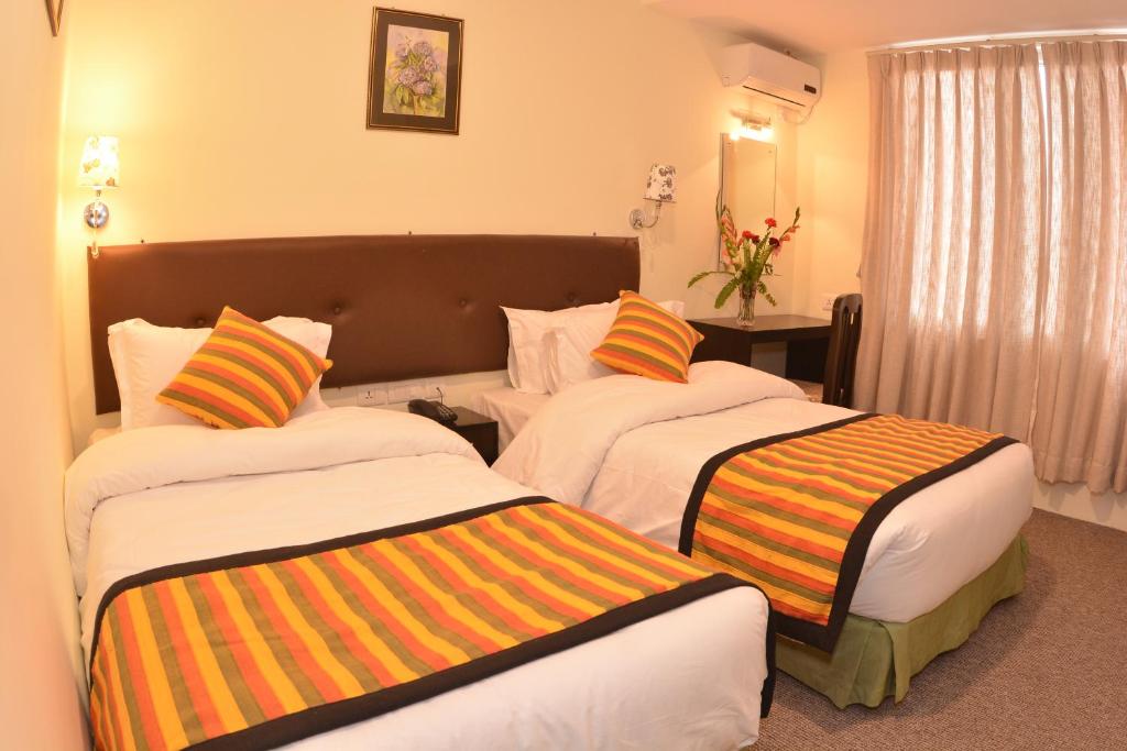 Postel nebo postele na pokoji v ubytování Hotel Serenity