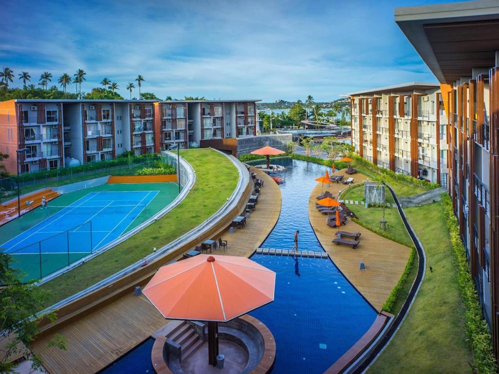 an aerial view of a hotel with a swimming pool and a pool at Replay Condo One Bedroom in Bang Rak Beach