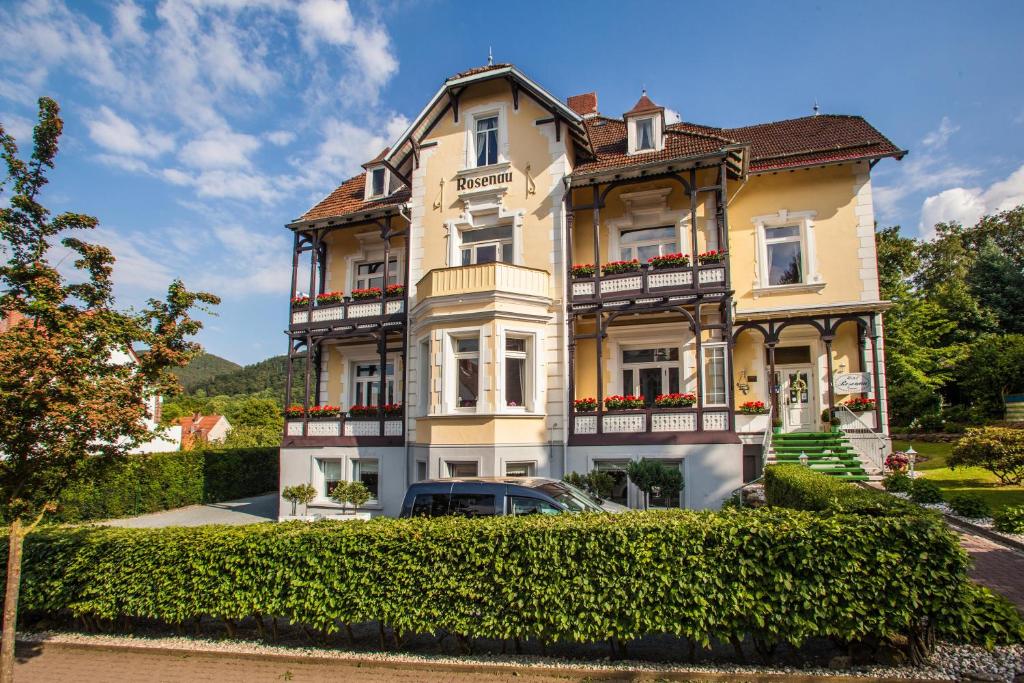 a house with a car parked in front of it at Hotel Rosenau in Bad Harzburg