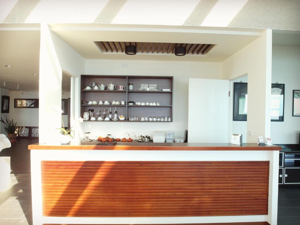 a kitchen with an orange and white counter top at Tea Cloud B&amp;B in Leye