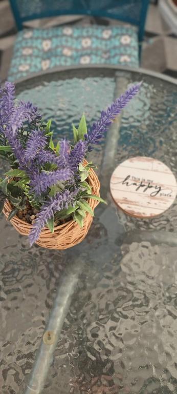 ヴルドニークにあるApartman Lavandaのガラスのテーブルの上の紫色の花のバスケット