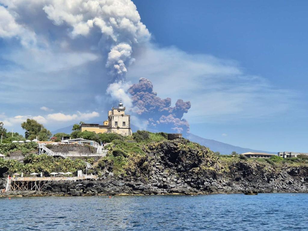a house on an island with smoke coming out of it at Casa Ludovica in Catania