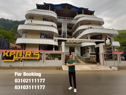 a woman standing in front of a building at Kabirs Hotel Kalam in Kalām