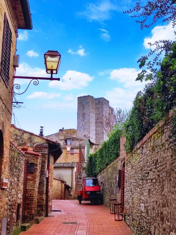 a street with a street light and a castle in the background at Sangi Home in San Gimignano