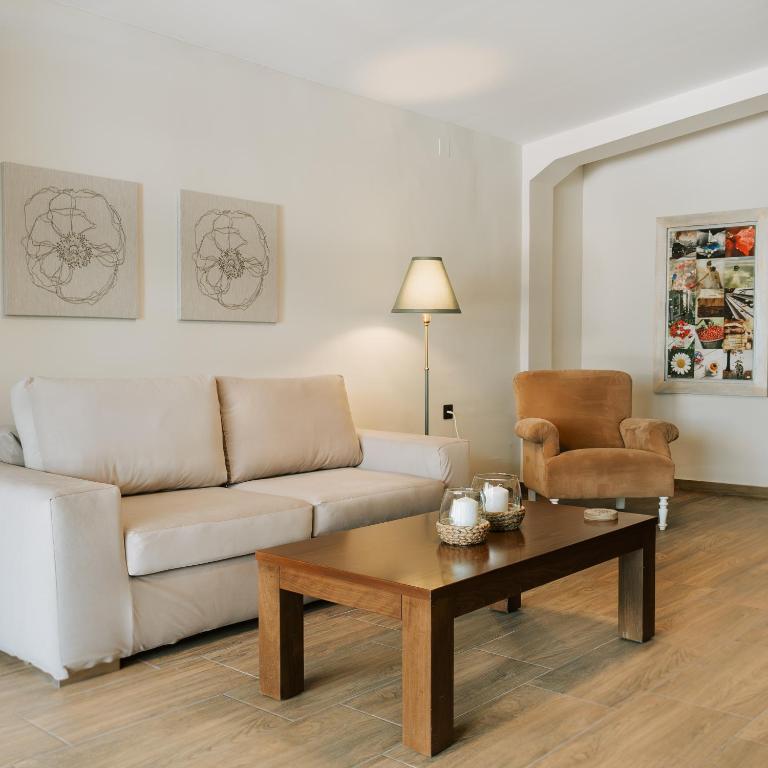 a living room with a couch and a coffee table at Lotos Families Apartments 5 in Konitsa