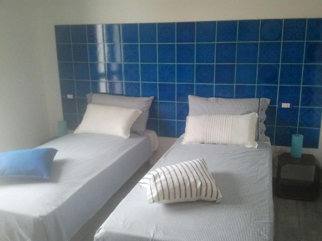 Een bed of bedden in een kamer bij B&B La Casa Bianca di Porto Conte