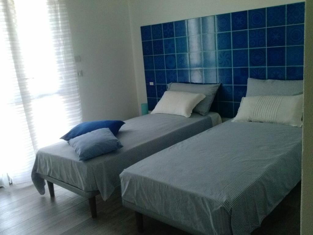 Een bed of bedden in een kamer bij B&B La Casa Bianca di Porto Conte