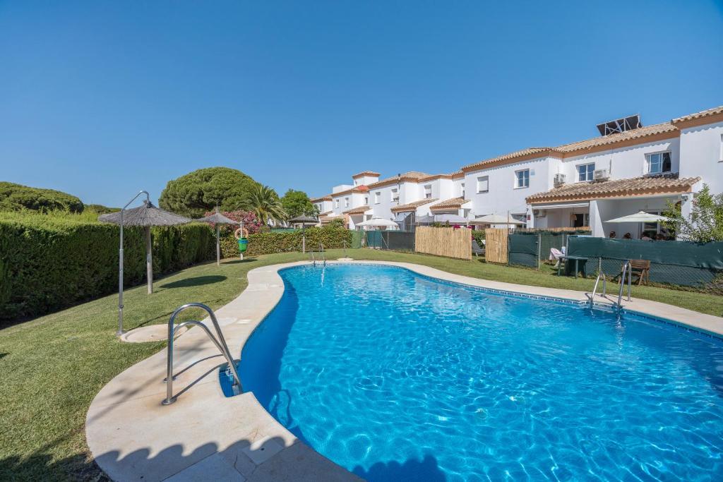 a swimming pool in the backyard of a villa at Villa Mirto Golf in Chiclana de la Frontera