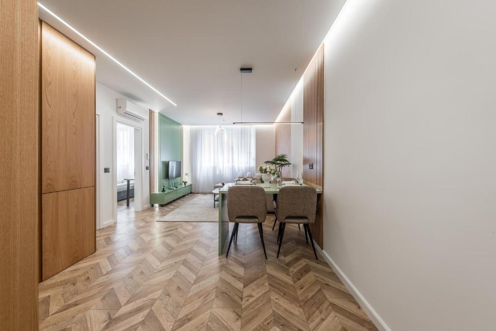 a kitchen and dining room with a table and chairs at Volga Promenade Apartment in Durrës