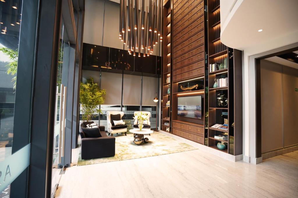 a living room with a chandelier in a building at Ascott Menteng Jakarta in Jakarta