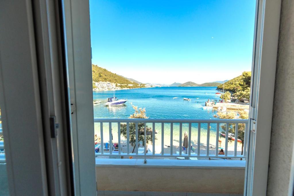 a view from a window of a beach and water at Apartmani Spajić Duboka by aneo travel in Klek