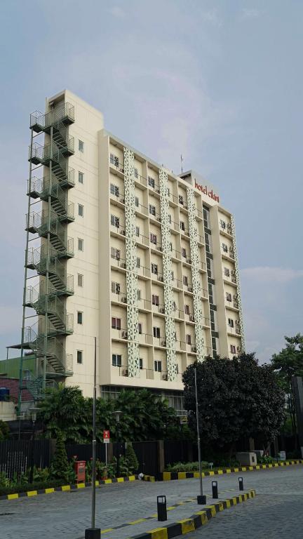 a large white building with a hotel at Hotel Cikini in Jakarta