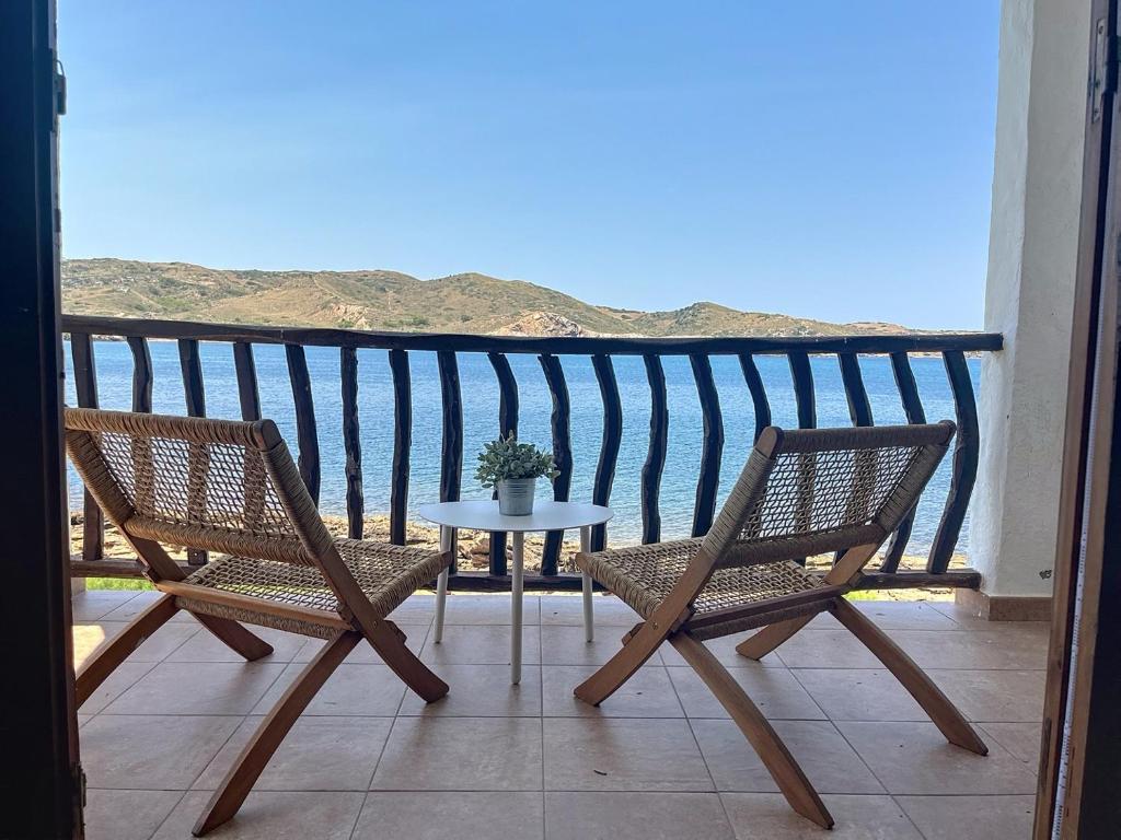 a balcony with two chairs and a table with a view at Roca Fornells, P131 in Fornells