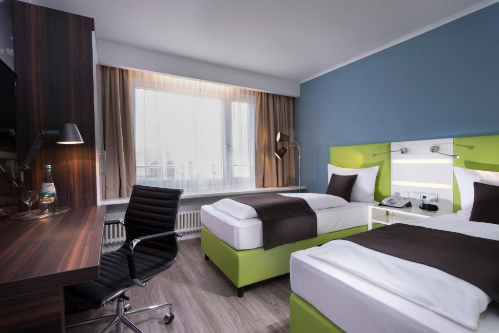 Postel nebo postele na pokoji v ubytování ibis Styles Offenburg City