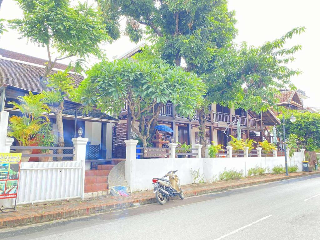 a motorcycle parked on the side of a street at Luang Prabang Golden Lotus Villa River View in Luang Prabang