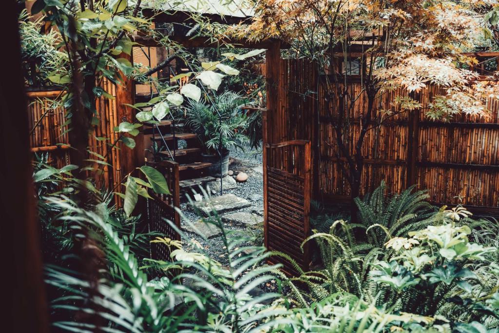 a garden with a fence and a wooden gate at Dali Fenghe Sansheng Homestay in Dali Ancient Town