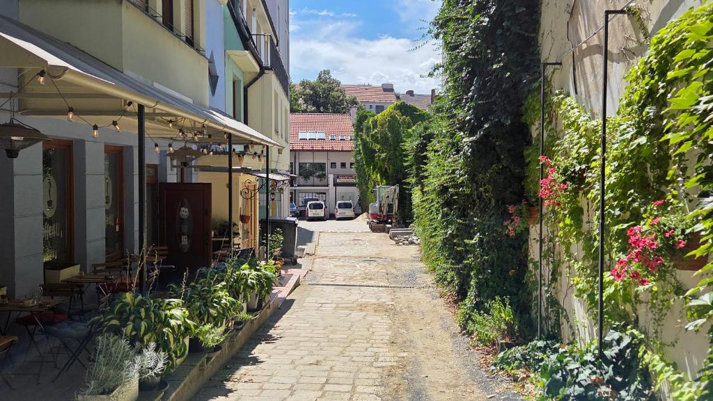an empty alley with plants on the side of a building at Apartment Residence Bratislava in Bratislava