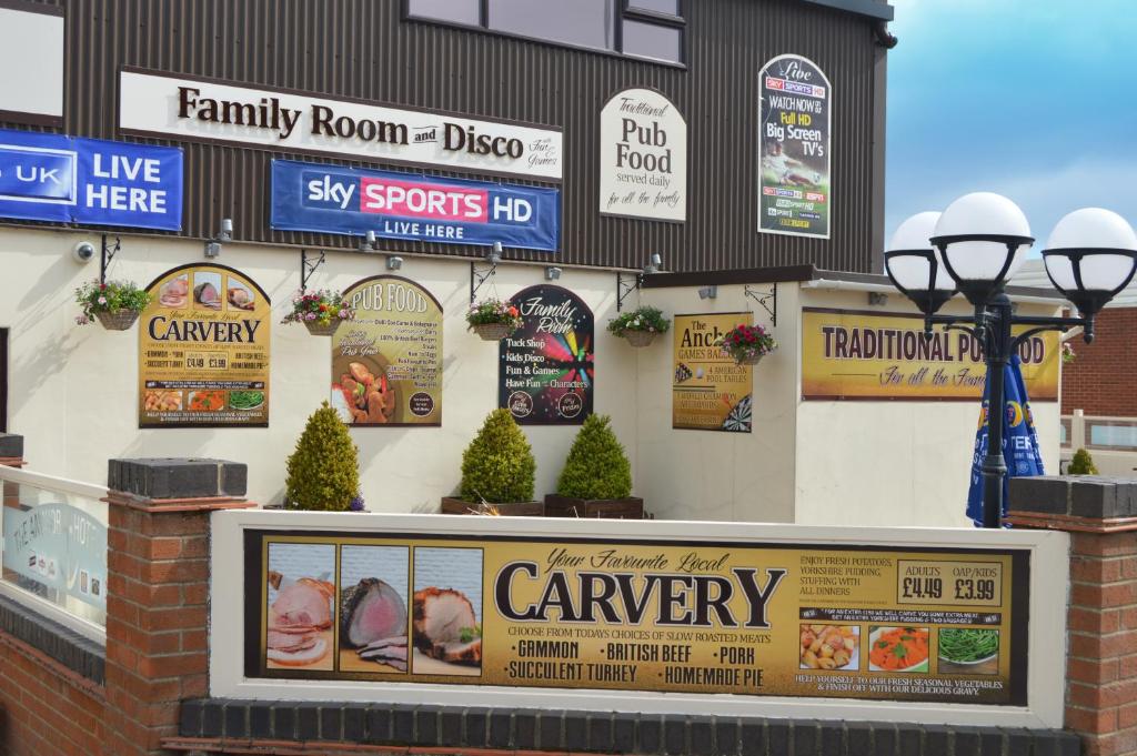 a building with signs on the side of it at The Anchor Hotel & Bars in Ingoldmells