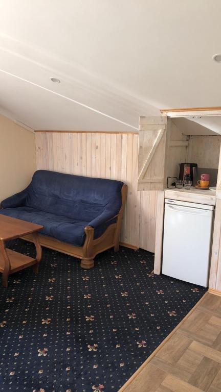 a room with a blue bed and a table at Номер з кондиціонером in Chernihiv