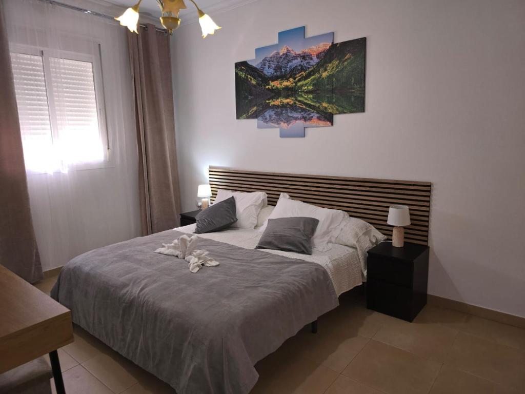 a bedroom with a large bed with flowers on it at Casa La Estación in Olvera