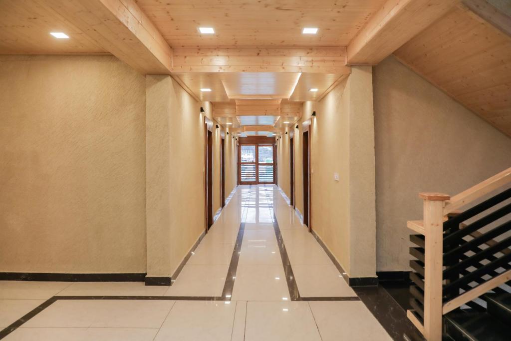 an empty corridor in a building with a long hallway at ECKO Premier New Yoga in Badrīnāth