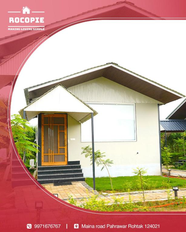a mirror image of a white house with a door at Rocopie Farm in Asthal Bohar