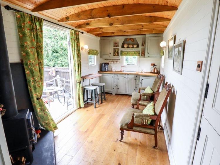 une cuisine avec un canapé et une cuisinière dans une pièce dans l'établissement Natures Nook - Luxury XL Wagon Louth Lincolnshire, à Louth