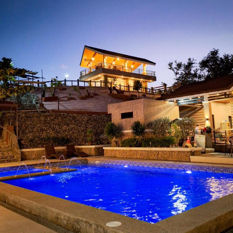 a swimming pool in front of a house at Villa Minerva Eco-Farm Resort near Vigan in Fuerte