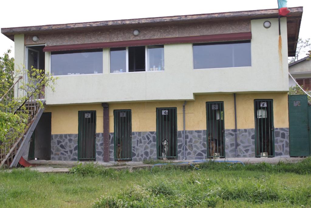 a house with black doors on the side of it at ХОТЕЛ за кучета Киноложки център СТИФ in Bŭnzareto