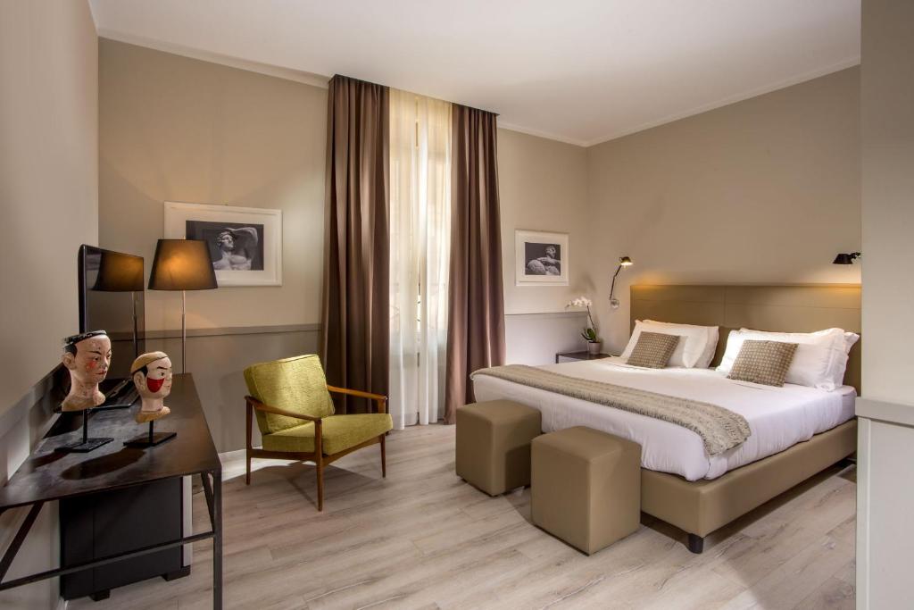 a hotel room with a bed and a desk at Nazionale 51 Group in Rome