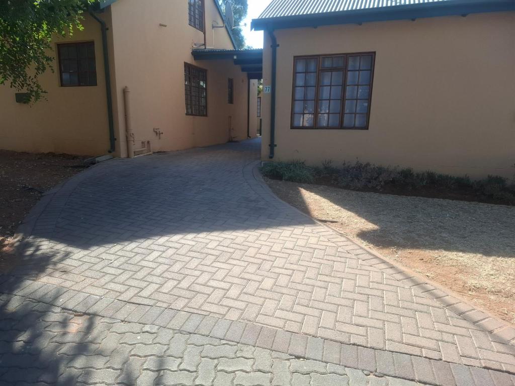 a brick driveway in front of a building at 77 Pendleberry Grove in Warmbaths