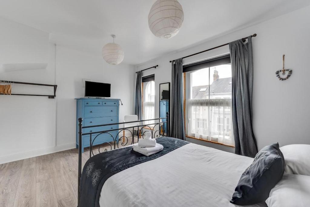 a bedroom with a bed and a large window at Arfryn in The Mumbles