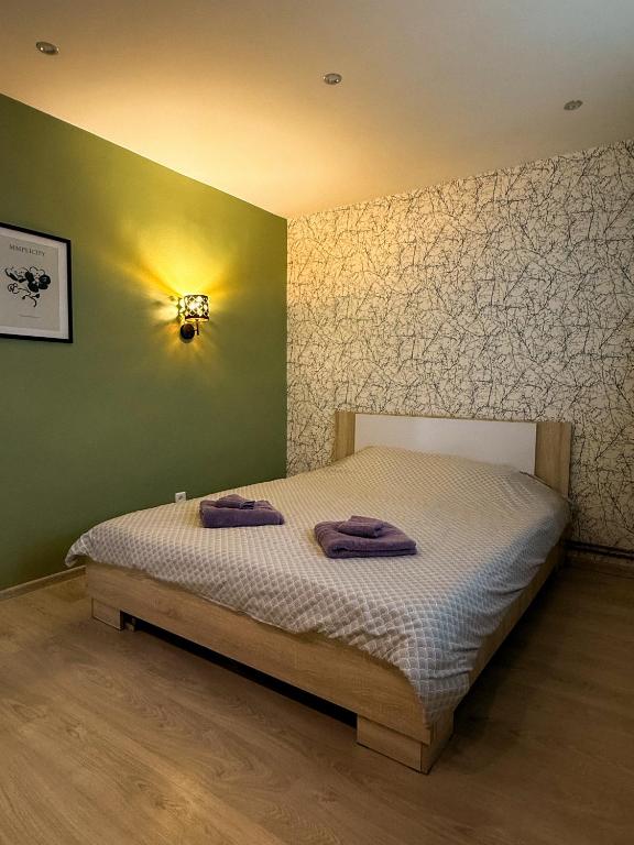 a bedroom with a bed with two towels on it at Piejūras laivinieks in Liepāja