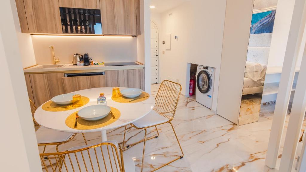 a kitchen with a table and chairs in a kitchen at Suite Sirmione Studio - Italian Homing in Sirmione