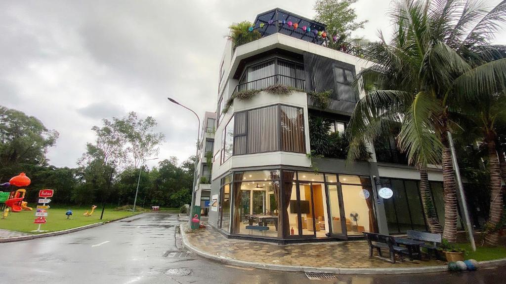 a building on the side of a street with a playground at Green Villa 5 phòng ngủ ở Flamingo Đại Lải Resort in Phúc Yên