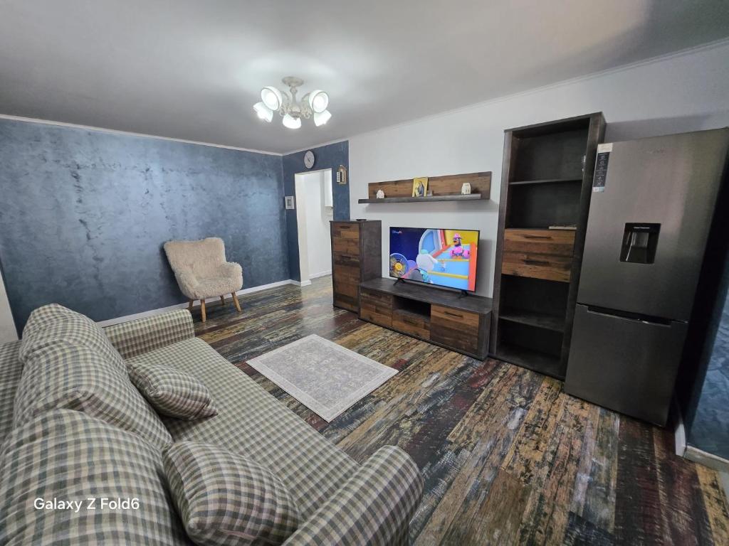a living room with a couch and a tv at David & Matei Residence in Jurilovca