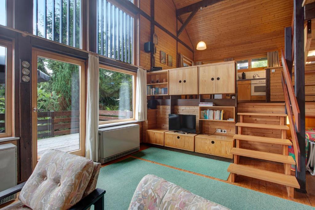 a living room with a staircase in a house at Haus 7 Bernau in Bernau im Schwarzwald