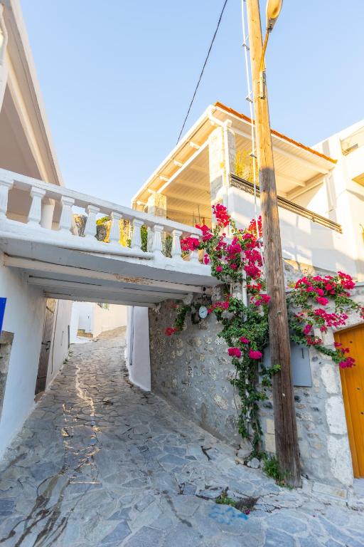 a balcony with flowers on the side of a building at The Bridge House in Spílion