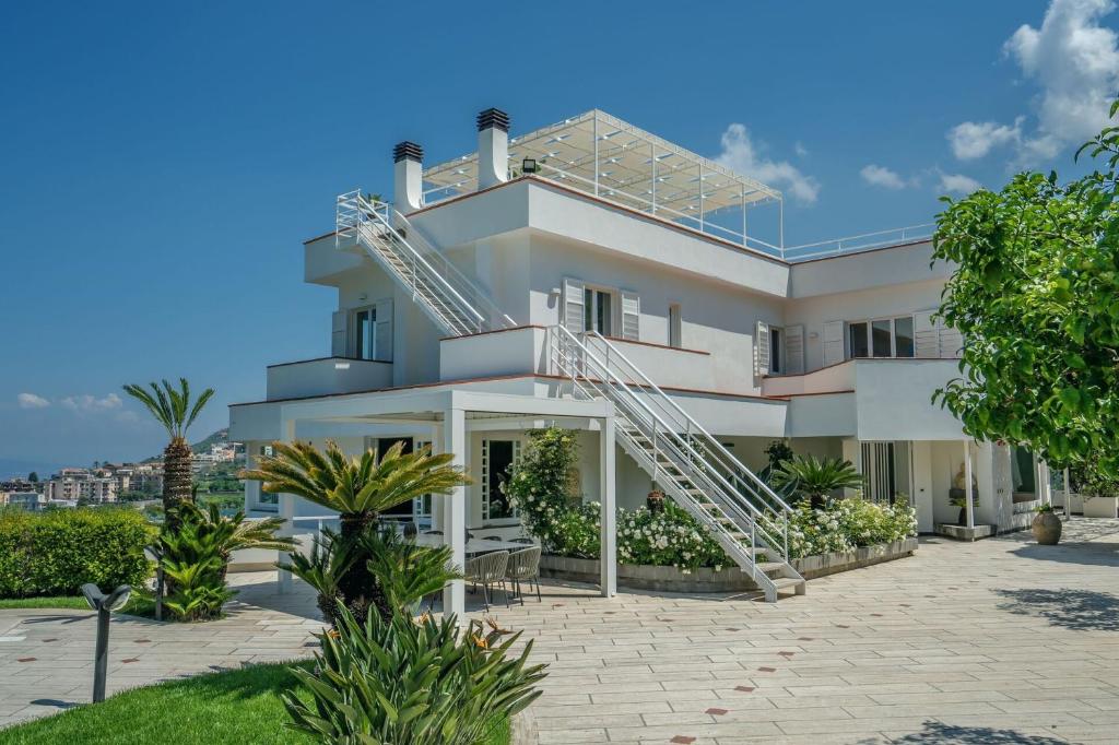 a white house with a spiral staircase on it at Luxury Levaina Villa Sleeps 8 on the Amalfi Coast in Positano