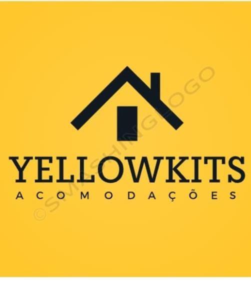 a logo for a yellow house on a yellow background at Yellow Hostel in São Paulo
