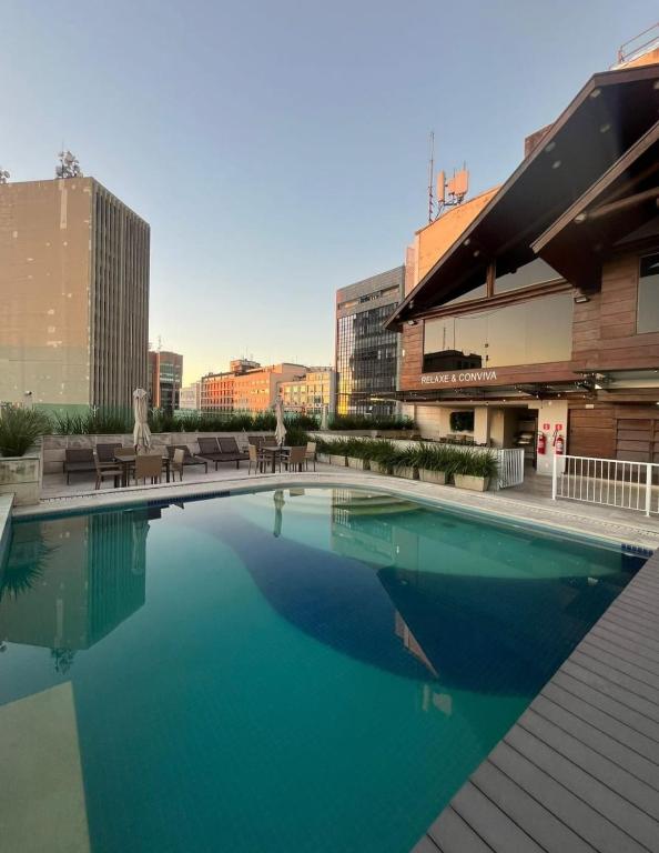 a large swimming pool on top of a building at Studio Alto Padrão Centro do Rio in Rio de Janeiro