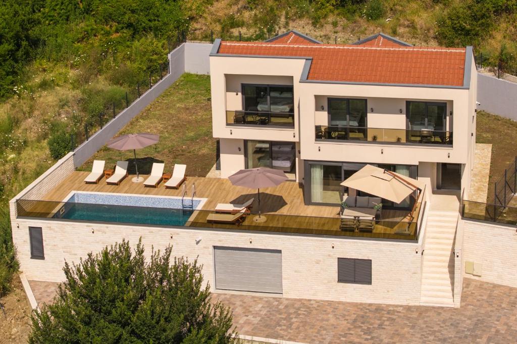 an aerial view of a house with a swimming pool at Villa Boka in Tivat