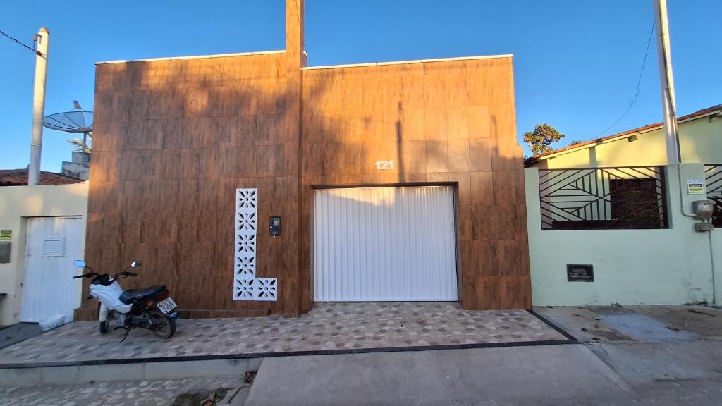 a motorcycle parked in front of a building at Casa temporada Martins,RN in Martins