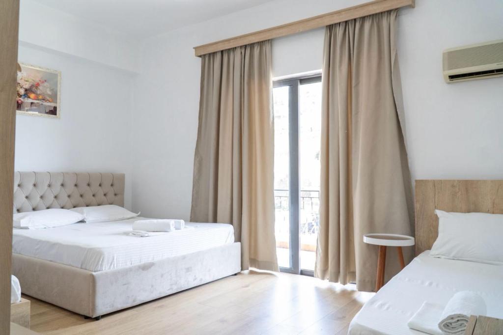 Postel nebo postele na pokoji v ubytování Sunny Days Hotel